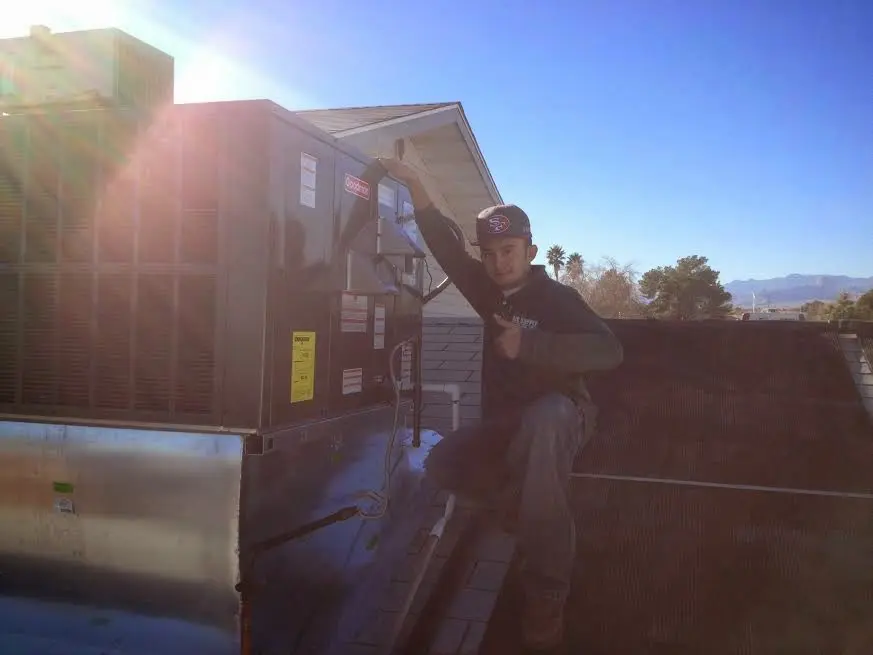 HVAC technician performing HVAC Inspection on a rooftop unit in Hockessin